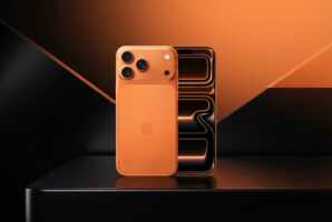 Smartphone posé sur un fond noir et orange assorti.
